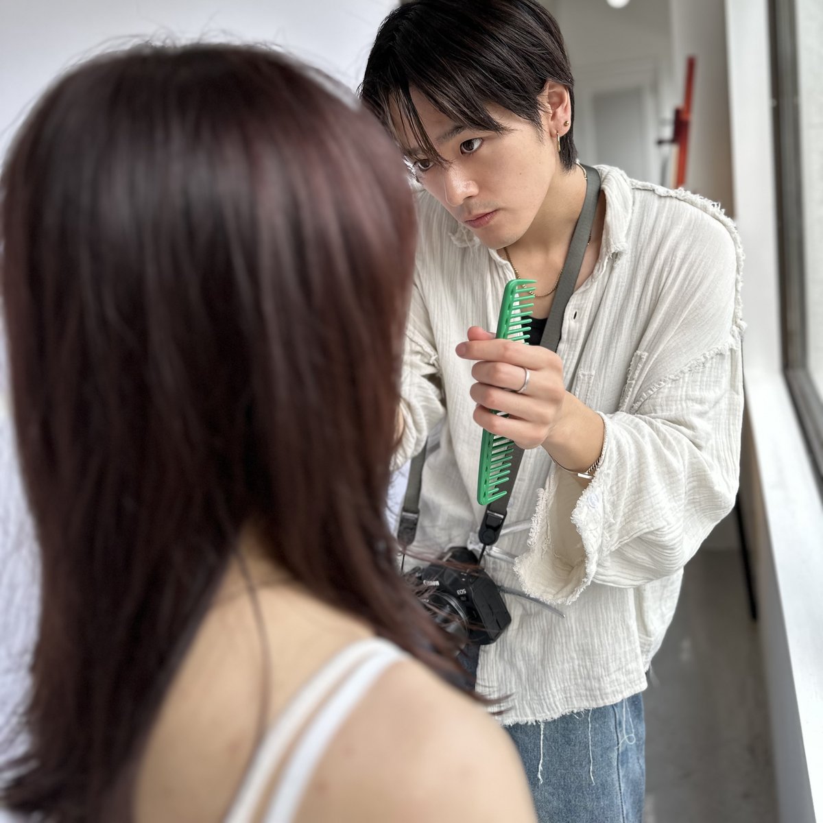 撮影前にスタイリストがモデルを仕上げる様子